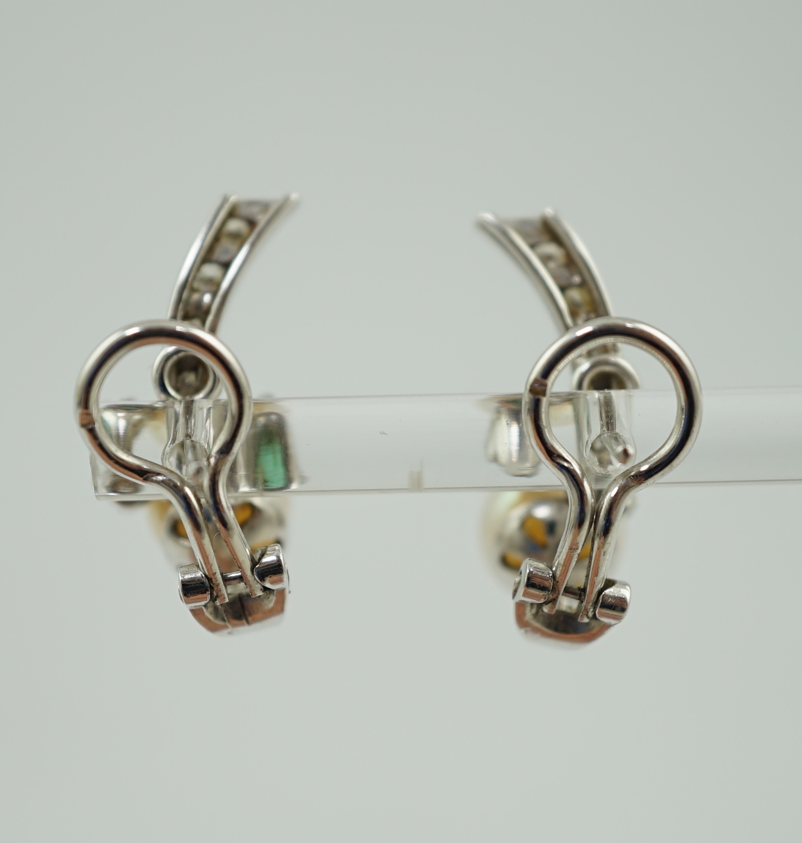 A modern pair of white gold, cultured pearl, emerald and diamond cluster set ear studs